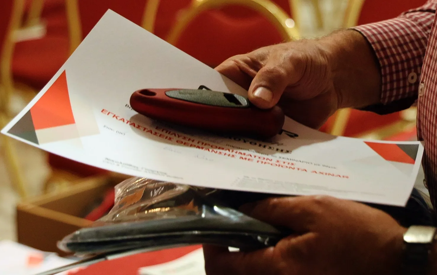 Participant holding certificate and tools at the end of Axinar Academy training seminar