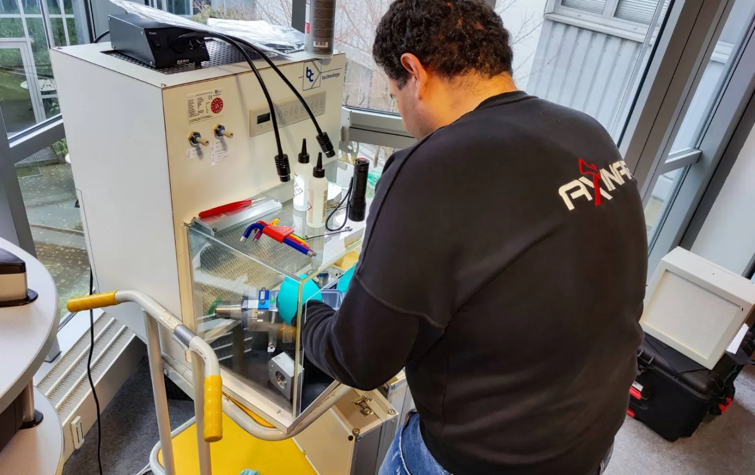 Axinar technician working with lab equipment during technical training session