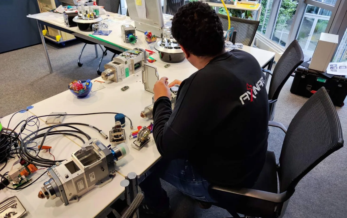 Hands-on training at Axinar Academy with electrical and mechanical components