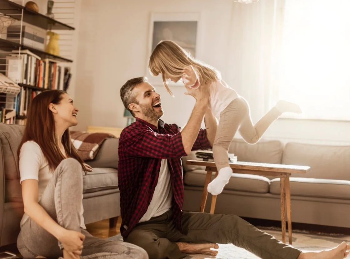 Happy family enjoying warm indoor environment in a cozy living room