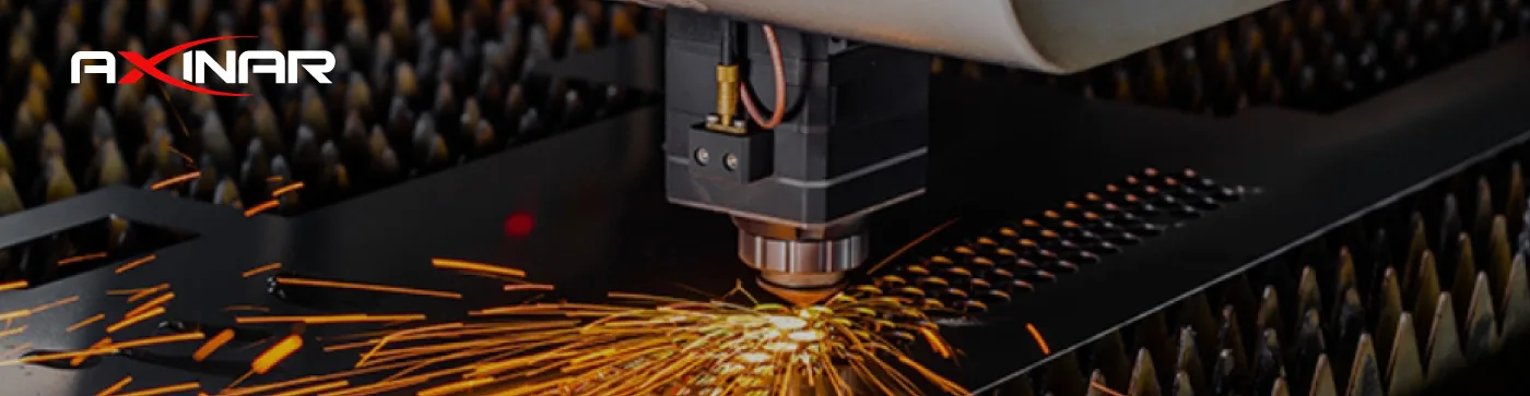 High-precision fiber laser cutting machine processing a metal sheet at Axinar's facility in Greece. Sparks flying during industrial CNC operation.